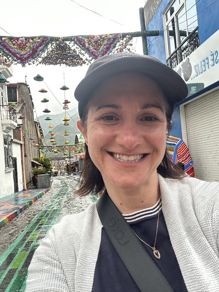 Neta, founder of SortMyDivorce, smiling on a colorful street